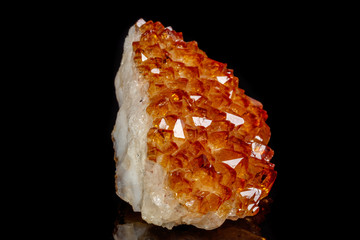 Macro mineral stone Citrine in rock in crystals on a black background