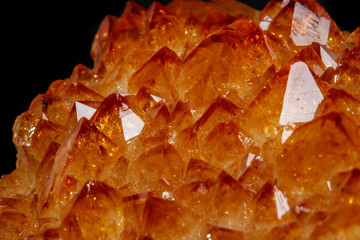 Macro mineral stone Citrine in rock in crystals on a black background