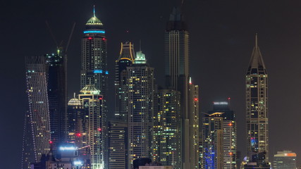 Fototapeta na wymiar Beautiful aerial top view at night timelapse of Dubai Marina in Dubai, UAE