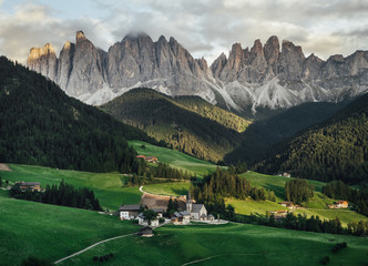 Mountain landscape. Santa Magdalena Village in the Dolomites Alps, Italy. Sunset in the mountains. Alpine meadows in the mountains.