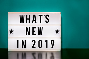 What's new in 2019 sign - cinema style lettering on light box & aqua/teal background