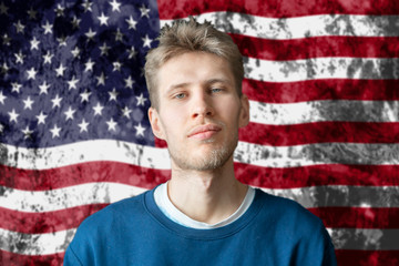 handsome american college student standing on american flag background b