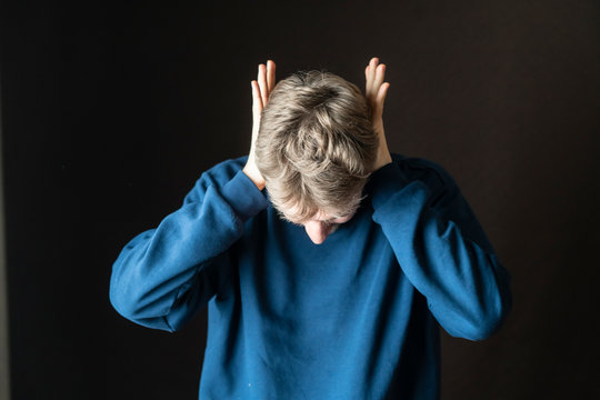 Young Stressed Male Protecting His Ears From Loud Irritative Noises F