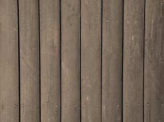 Close up of brown painted wooden fence panels.