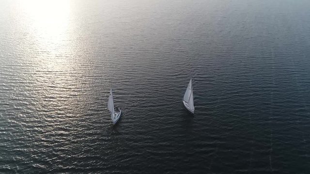 Aerial footage of two sloop vessels are sailing boats with single mast one head sail and fore plus aft rig the most common configuration of modern sailboats is the Bermuda-rigged one 4k quality