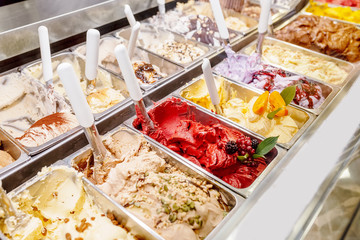 various flavors of gelato ice-cream at the showcase in dessert shop - obrazy, fototapety, plakaty