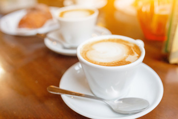 Cappuccino coffee cup on the table in cafe