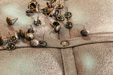 Furniture decorative nails on the background of fabric upholstery