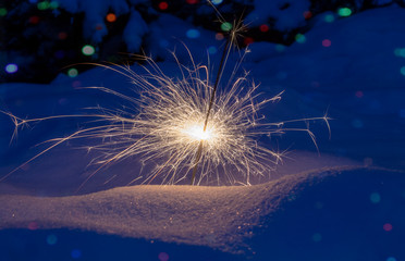 Festive background. Bengal fire, fireworks, spark, snow, bokeh effect. Christmas or New Year....