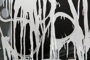 Close-up Of Smudges Of White Paint And Splashes On Black And Gray Wall. Grunge Old And Dirty Wall.