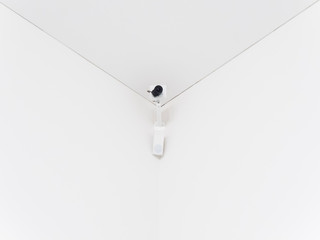 surveillance camera in a room corner with clean white background