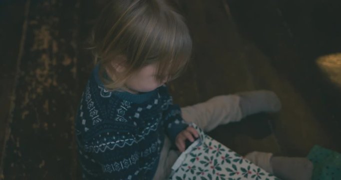 Little toddler opening christmas presents