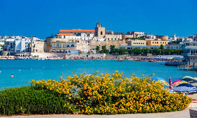 Cityscape of the beach and city architecture in summer holiday in Otranto, Lecce region in Italy - obrazy, fototapety, plakaty