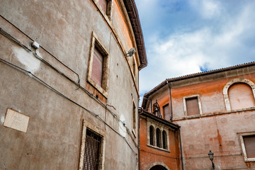 A view of Piazza Dante. Ancient building with arch, three windows and bell. Anagni, Frosinone, Italy.