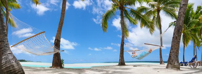 COPY SPACE: Young female tourist relaxing on the sandy beach by the ocean.