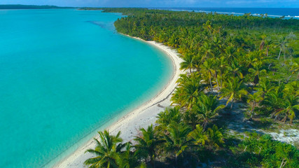 Fototapeta na wymiar DRONE Calm turquoise ocean washing the untouched sandy coast of tropical island.