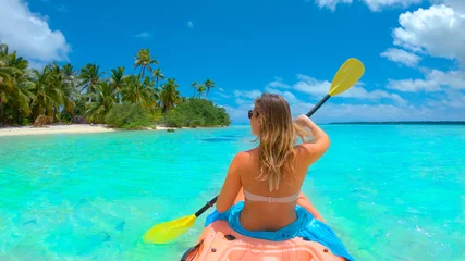 Foto op Canvas CLOSE UP: Young woman kayaking during her fun active vacation in Cook Islands. © helivideo