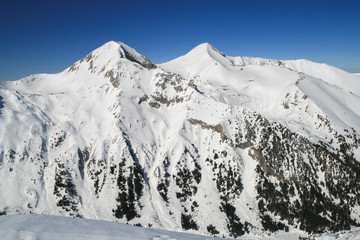 Winter landscape with hills covered with snow at Pirin Mountain, view from Todorka peak, Bulgaria