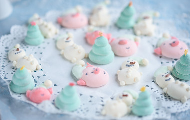 Fototapeta na wymiar Tasty and beautiful marshmallows in the form of: Christmas trees, muzzles of pigs, snowmen,