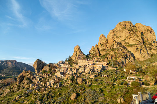 Piccolo paese abbandonato in montagna con case e chiese sul pendio vicino le rocce in Calabria. Pentedattilo.