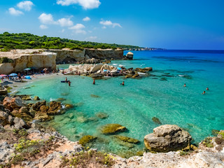 Fototapeta na wymiar Coastline of Faraglioni and beach on Puglia 