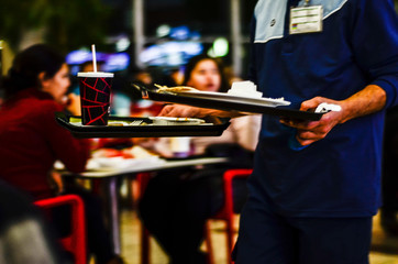 the attendant carries dirty dishes