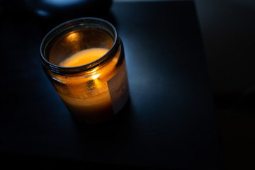 Candlie light on black table in the dark
