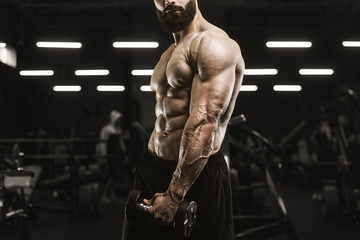 Fototapeta premium Handsome strong athletic men pumping up muscles workout bodybuilding concept background