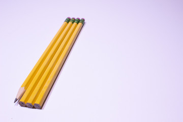 Fototapeta premium Shapened and unsharpened pencils on white background with copy space