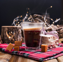 Fragrant fresh coffee in a holiday with traditional sweets. Christmas decor and the atmosphere of...