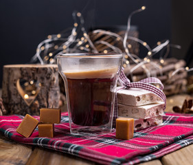 Fragrant fresh coffee in a holiday with traditional sweets. Christmas decor and the atmosphere of...