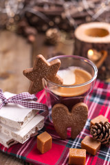 Fresh aromatic coffee and Italian Christmas sweets. Nougat with almonds, karemelnye sweets, ginger cookies and hot drink. Candles and holiday decorations. Free space for text.