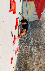 Sport man hanging extreme sport climbing wall in outdoor gym