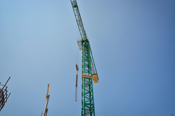 Fototapeta na wymiar Crane on construction site against blue sky