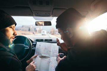 Bank robbers,planning their next hit while holding a gun and counting on a stop watch the time they...