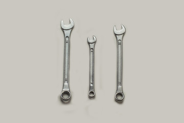 Top view, Stainless steel three wrenchs or spanners size 12,13,14 mm on isolated white background