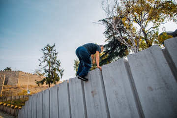 Training day of pakorur guy while climbing on concrete wall