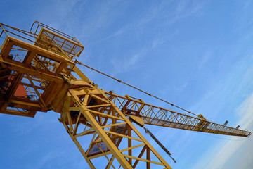 Construction crane. Yellow construction crane against a clear sky.