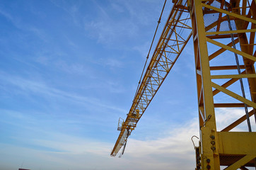 Construction crane. Yellow construction crane against a clear sky.