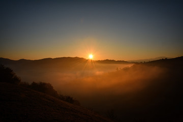 the morning autumn landscape with fog Holbav,Romania