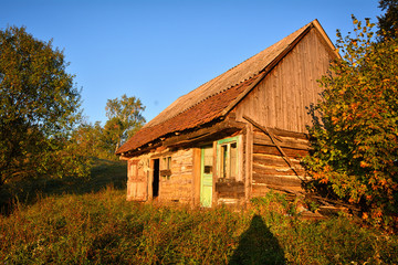 Naklejka na ściany i meble Isolated and abandoned mountain cabin in the woods