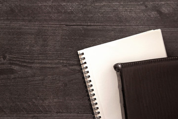 A Single Black Bible Laid Out on a Black Wooden Table