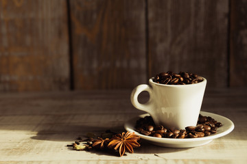  Cup with coffee beans on a wooden table