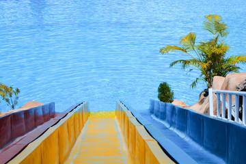 Fototapeta na wymiar Water park / Slider in swimming pool in the water park - Ripple Water surface in background