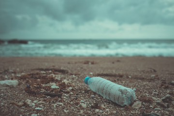 Trash, plastic, garbage, bottle... environmental pollution on the beach. Royalty high-quality free stock photo image of trash, plastic bottle on the beach. Waste that polluted the ocean environmental