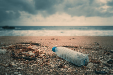 Trash, plastic, garbage, bottle... environmental pollution on the beach. Royalty high-quality free stock photo image of trash, plastic bottle on the beach. Waste that polluted the ocean environmental