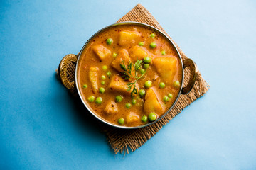 Indian Aloo Mutter curry - Potato and Peas immersed in an Onion Tomato Gravy and garnished with...