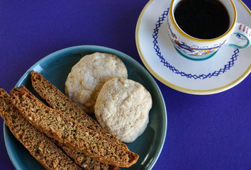 Espresso coffee and plate of fresh baked cookies, including Italian biscotti