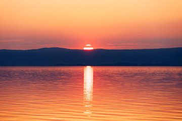 Fototapeta premium Beautiful sunset or sunrise above the sea. Tropical sunset or sunrise over sea. Colourful sunset or sunrise over water.