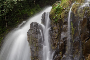 Fototapeta premium Cold mountain water cascades over rocks on its journey to the ocean.